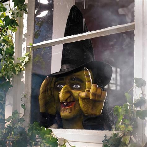 Halloween window decoration with tapping witch